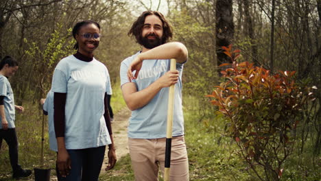 Portrait-of-two-activists-clearing-up-the-forest-surroundings