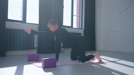 woman doing yoga in a studio