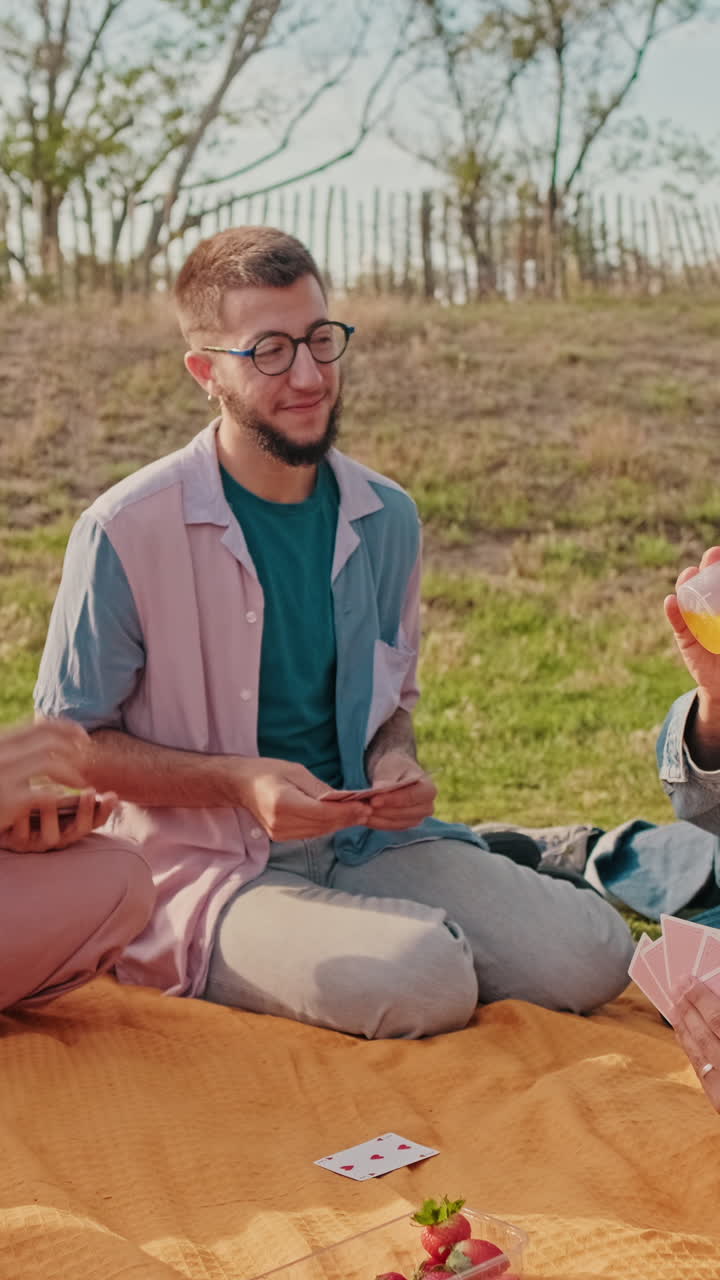 Friends Playing Cards at a Sunny Picnic