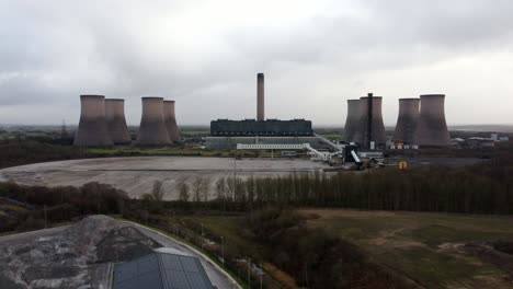 aerial reversing view across coal fired power station site, fiddlers ferry overcast smokestack skyline