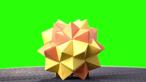 modular origami ball on green screen.