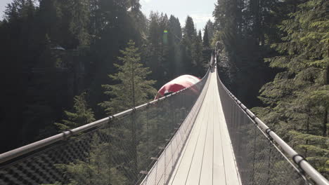 walking on empty suspension bridge with canadian flag