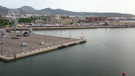 ascending images of the harbor where the world cup jet ski was held in olbia show the buoys still in the water and the seagulls following the drone like an intruder