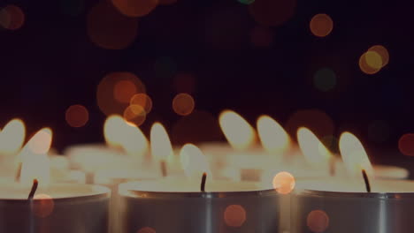 animation of christmas flickering lights over lit candles