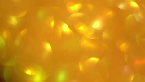 quick movements of the flickering background. blurred texture of golden radiance. seamless texture with yellow gold sequins