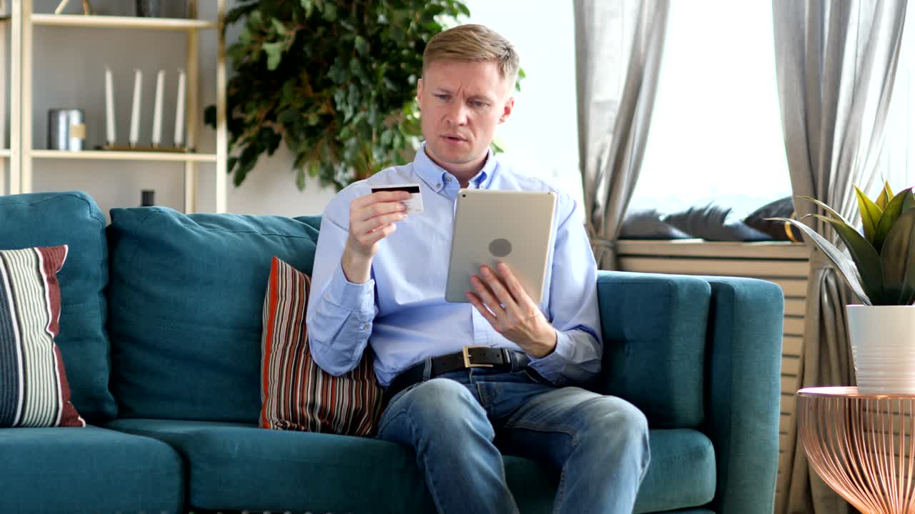 Online Shopping on Tablet PC by Sitting Middle Aged Man