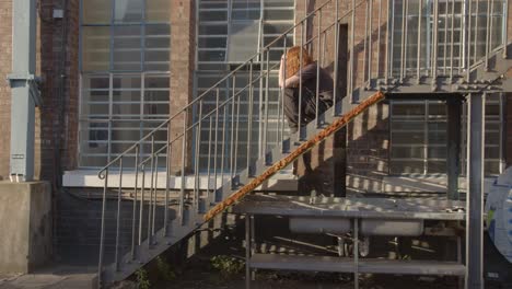 person sitting on metal staircase outside the bussey building on copeland road in peckham south london uk 2