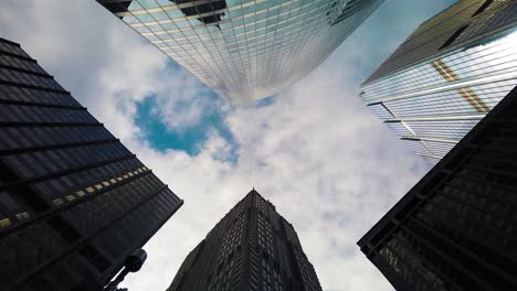 timelapse of downtown city buildings and white clouds