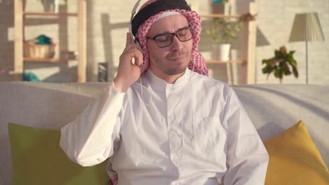 portrait of arab man listening to music with headphones