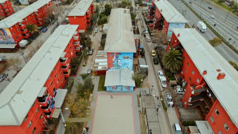 Flyover establishing descent in the open-air museum of San Miguel in Santiago de Chile, residential blocks of a neighborhood recovered by art