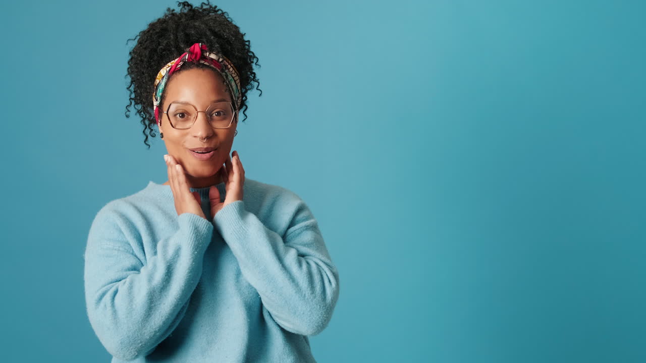 Young Black Woman Expressing Surprise and Then Smiling