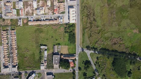 top-down view of a small country town with few houses and lots of green space available for housing on a sunny day in the afternoon brazil porto real