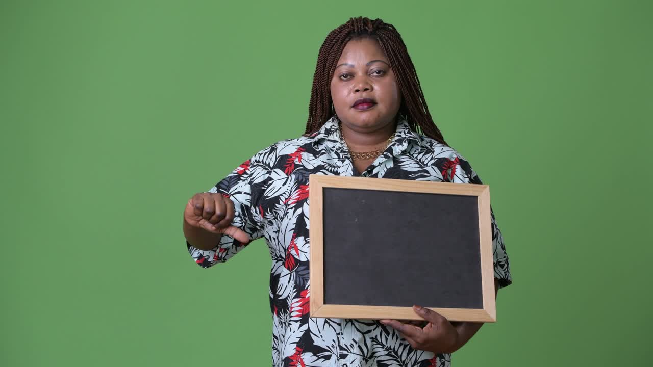 Overweight beautiful African woman against green background