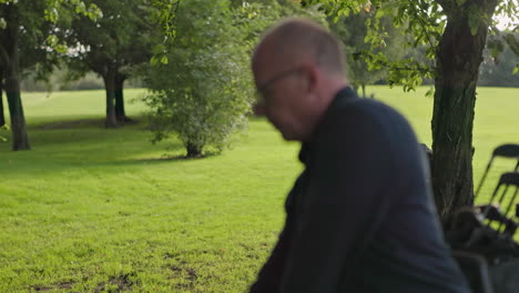man with golf clubs on a golf course