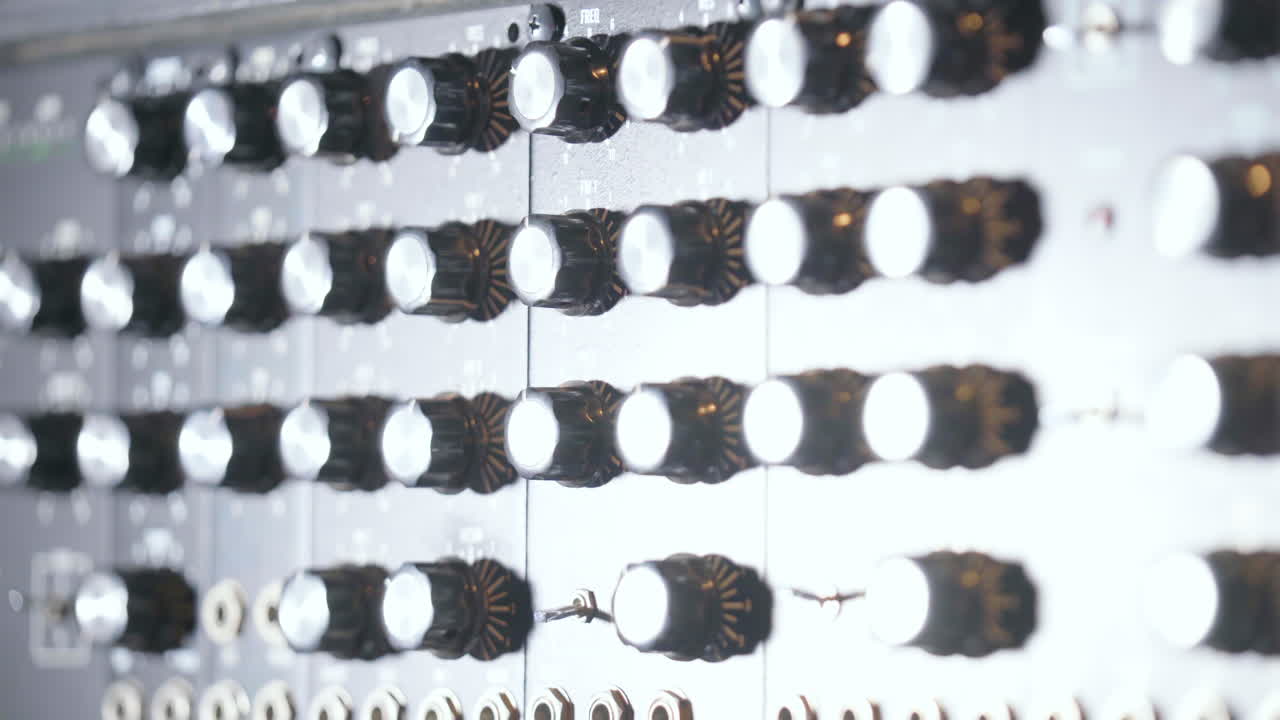 Close up of light changing on audio buttons in professional sound recording studio