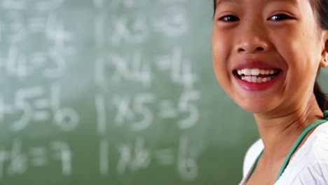 Schoolgirl-using-mobile-phone-in-classroom