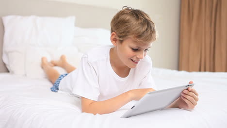 Smiling-boy-using-a-tablet-pc