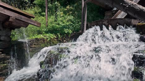 Bubbling-gushing-flowing-splashing-water-cascades-from-sluice-flume-,-slow-motion