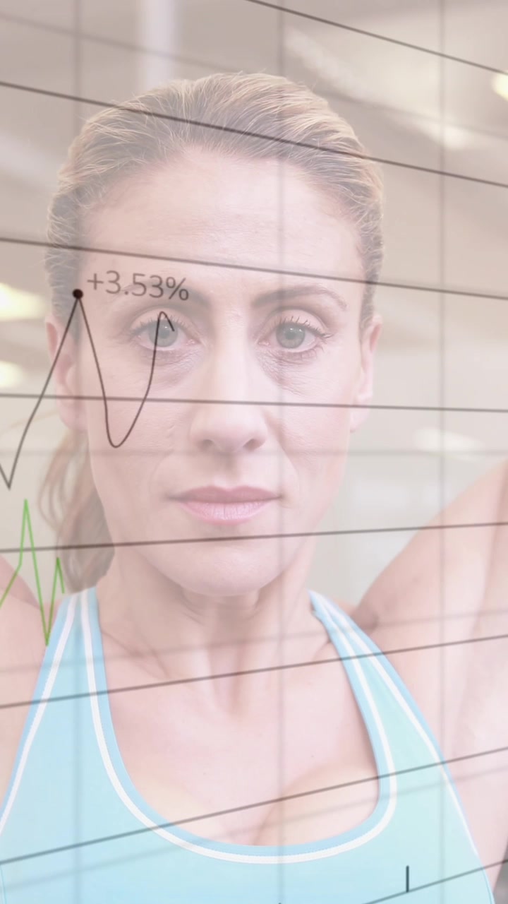 Animation of statistical data processing over caucasian fit woman working out with dumbbells at gym