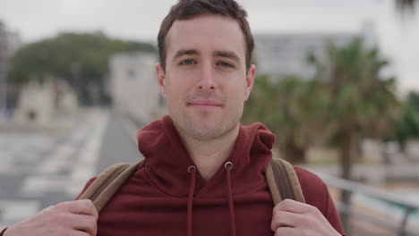 portrait confident young man smiling enjoying successful vacation lifestyle independent male student summer travel in urban seaside background slow motion