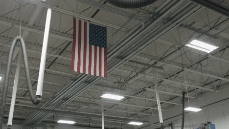 an american flag hangs from the ceiling of an auto garage