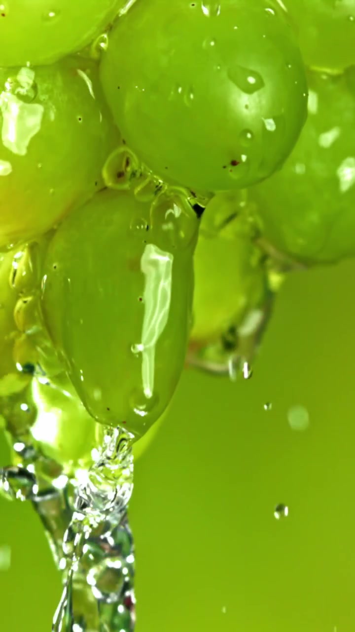 Close-up of Fresh Green Grapes Being Washed with Water