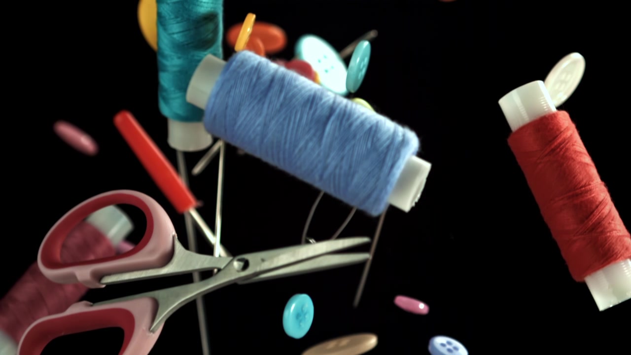 Vibrant Sewing Notions and Tools Falling in Slow Motion