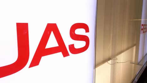 brightly lit "rebajas" sign signals discount season in a store, captured with camera panning right