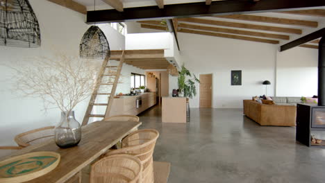 Modern open-plan living area with wooden furniture and indoor plants