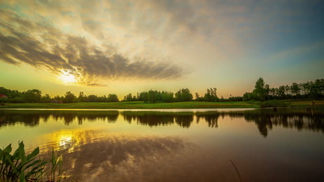timelapse view of a sunrise over a lake and countryside