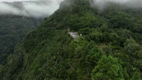 aerial view of a winding mountain road in a foggy forest