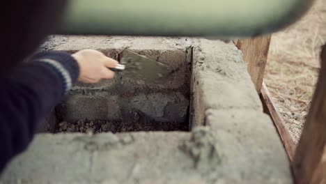 a man plastered cement brick layer on diy hot tub