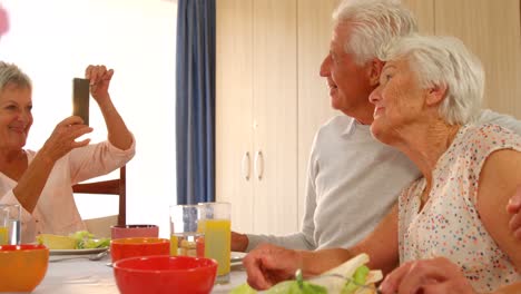 Senior-couple-being-photographed-by-a-friend