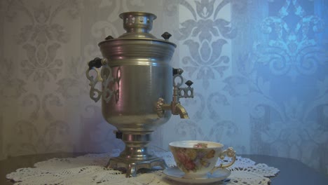 vintage samovar metal tea kettle illuminated by blue and pink light