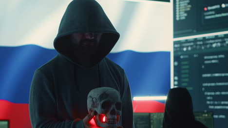 Conceptual image of a hooded russian hacker creating hazardous alerts