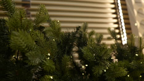 Vertical-Shot-Of-Christmas-Tree-Embellished-With-Lights-In-A-Shopping-Mall