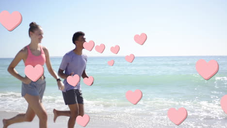 animation of pink hearts over diverse couple running on beach