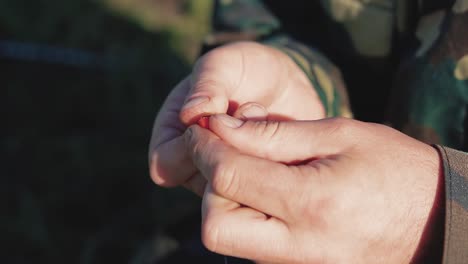 fisherman fixes the earthworm on a fishing hook