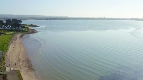 Birds eye view above Waterford sandy beach seaside on sunny day