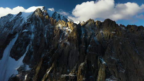 cinematic rotating epic drone shot of a large mountain top in the ak-sai glacier in kyrgyzstan