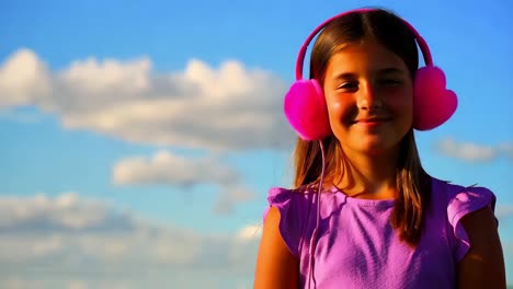 smiling girl with pink headphones