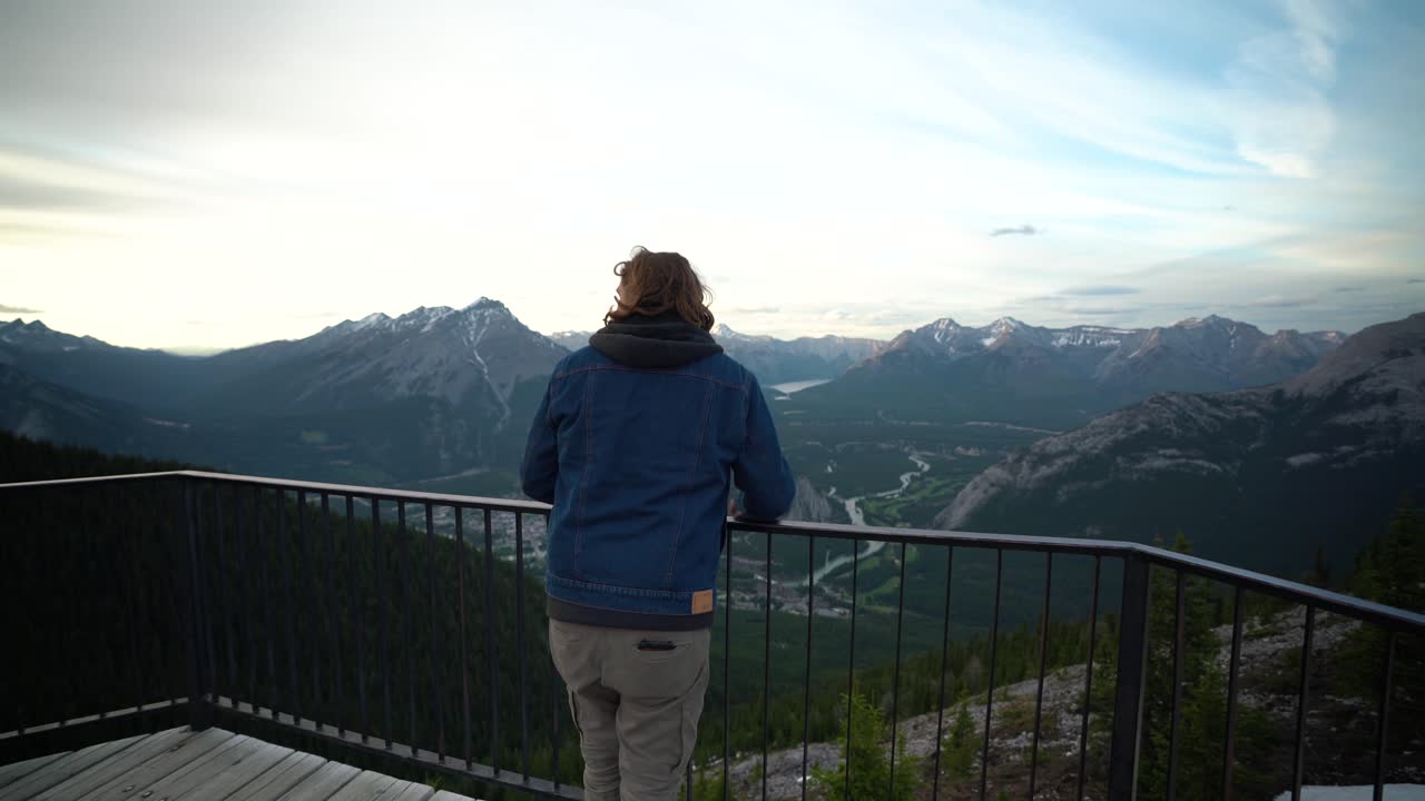Young handsome man looking out over Jasper National Park, Alberta, Canada