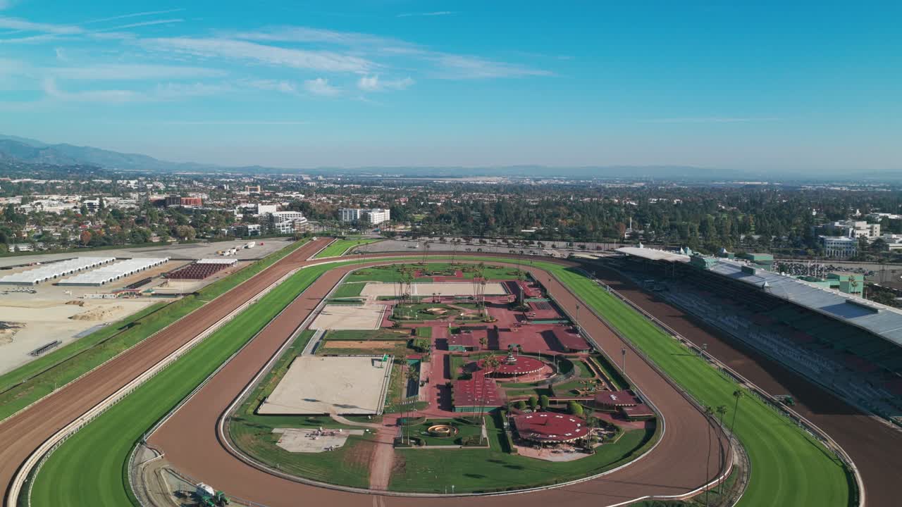 Aerial wide reverse pullback shot of the horse racing track at Santa Anita Park in Arcadia, California. 4K