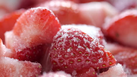 fresh ripe red strawberries being washed and sprinkled with sugar in a kitechen environment