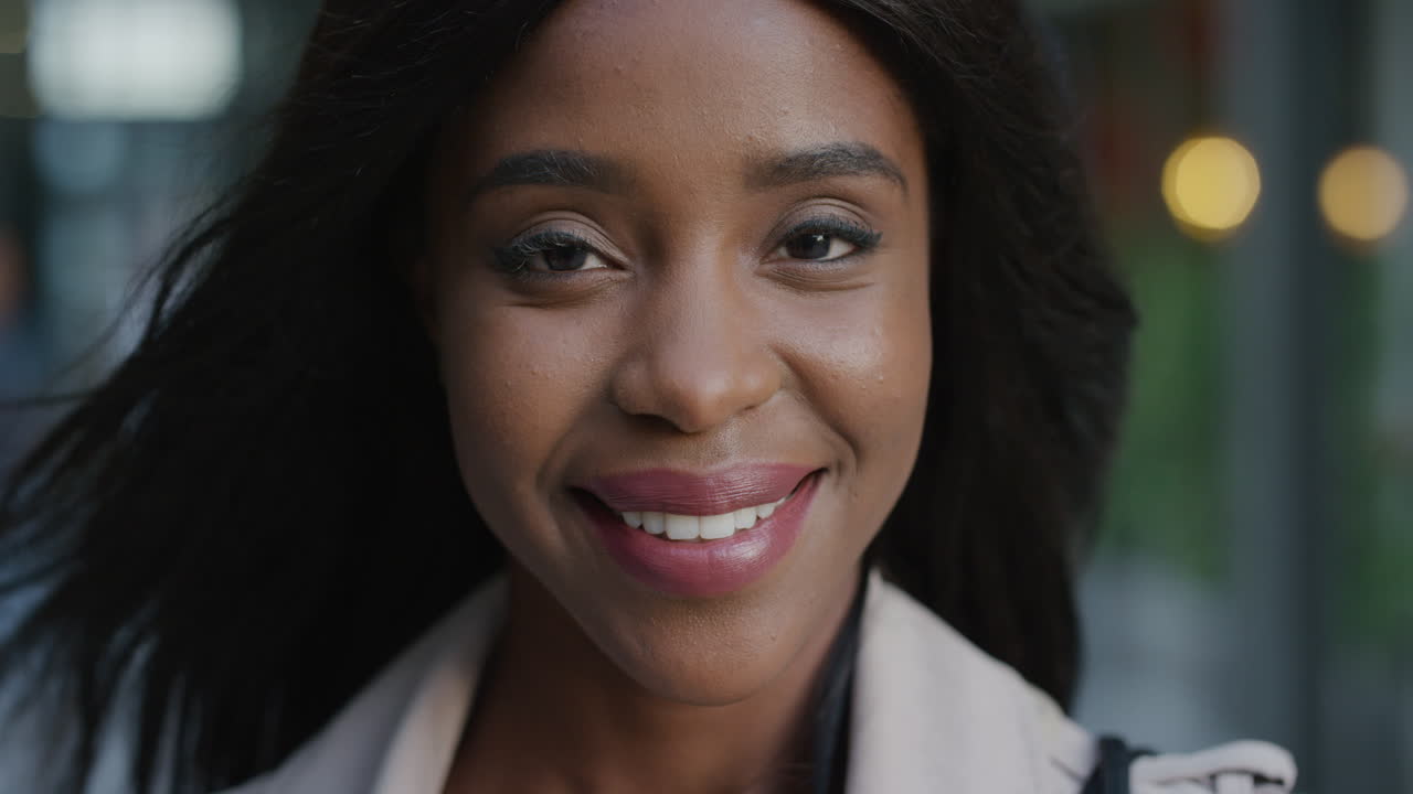 close up portrait attractive young african american business woman smiling independent female enjoying urban lifestyle wind blowing hair black feminine beauty