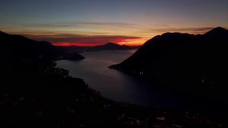 Amazing-Orange-Red-Sunset-Light-Against-Silhouette-Mountains-Over-Calm-Lake-Iseo-In-Lombardy,-Italy