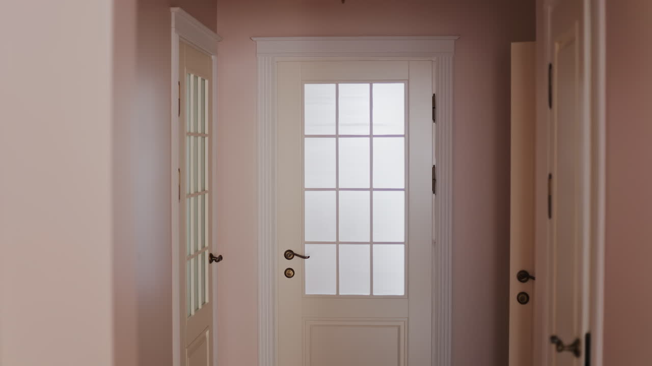View of white doors in a home with pink walls