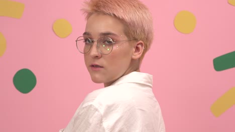 girl with short dyed blond hair round glasses and stars eye makeup