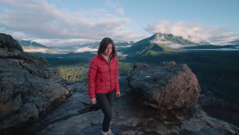 girl hiking up to rocky vantage point overlooking in washington state