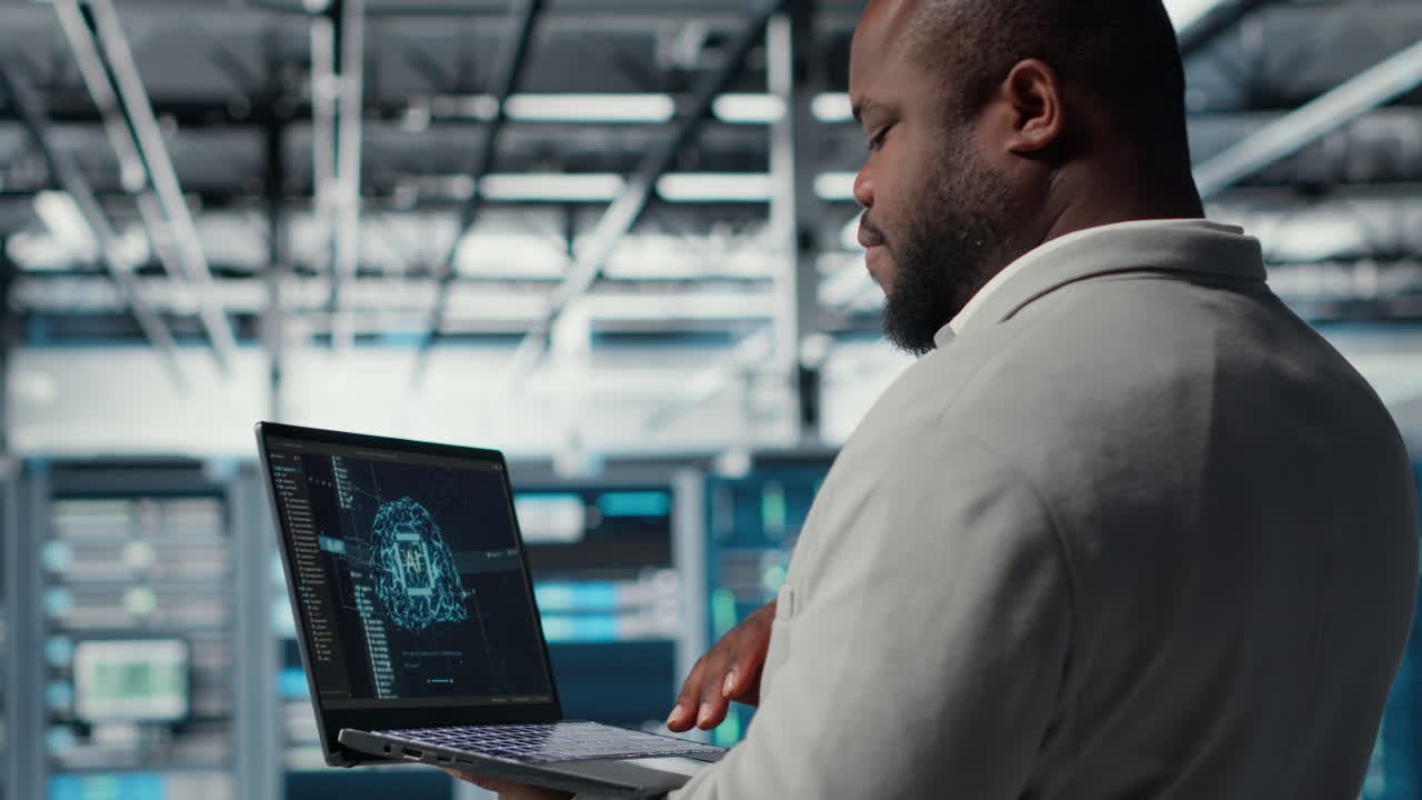 Vertical video Software developer in data center uses AI technology on laptop